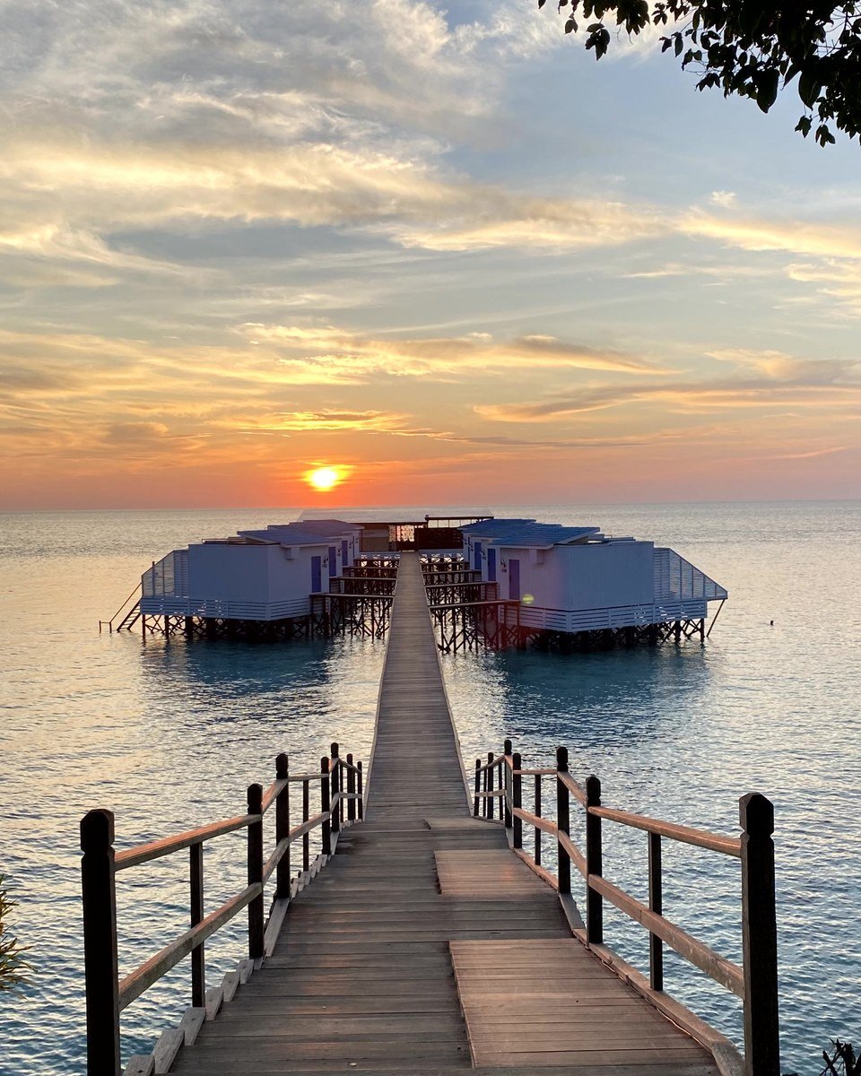 Sunset over the boardwalk between Arasatu's Floating Villas.