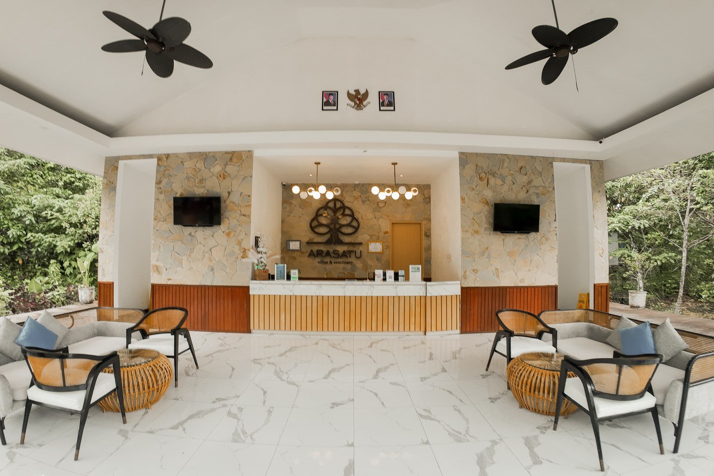 The open-air Arasatu lobby framed by Maratua's tropical forest.