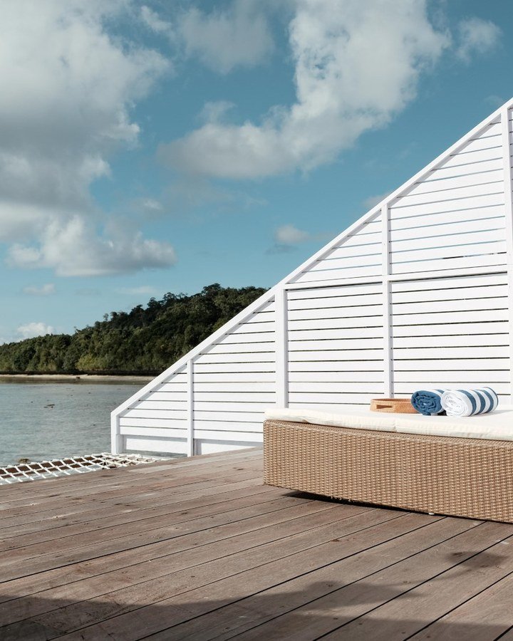 A Floating Villa balcony looking across the clear water at Arasatu.