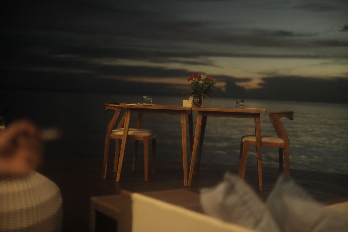 An intimate table for two beside the sea at Samamea after sunset.