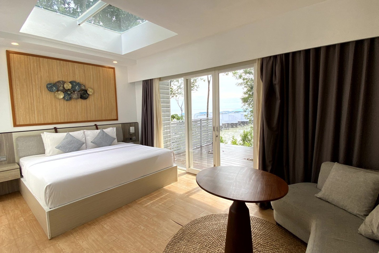 Sea View Villa bedroom with a skylight and views toward the Floating Villas.